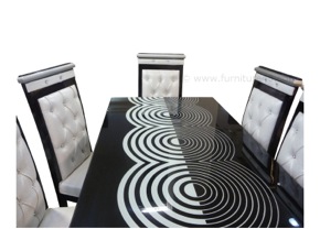 White and black designer dining table with lacquered glass. 6 artistic chairs. Highly irresistible and the one for you if you like designer products and want to make your relatives fill with awe on seeing it.